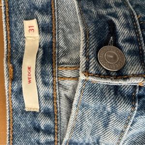 Wedgie fit, Ankle length Raw hem. High waisted, button fly rigid denim.